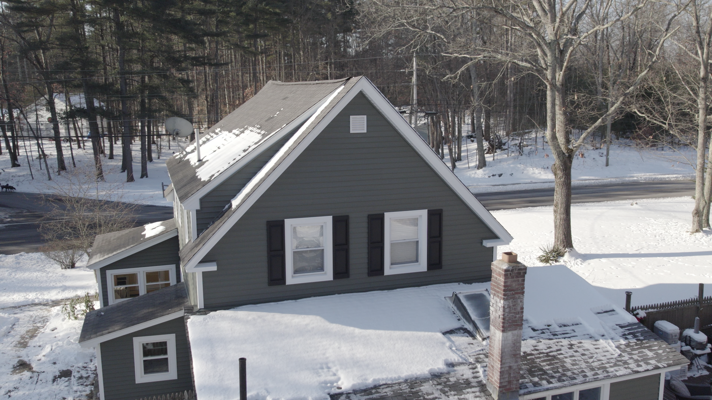 Close aerial view of a snow-covered home