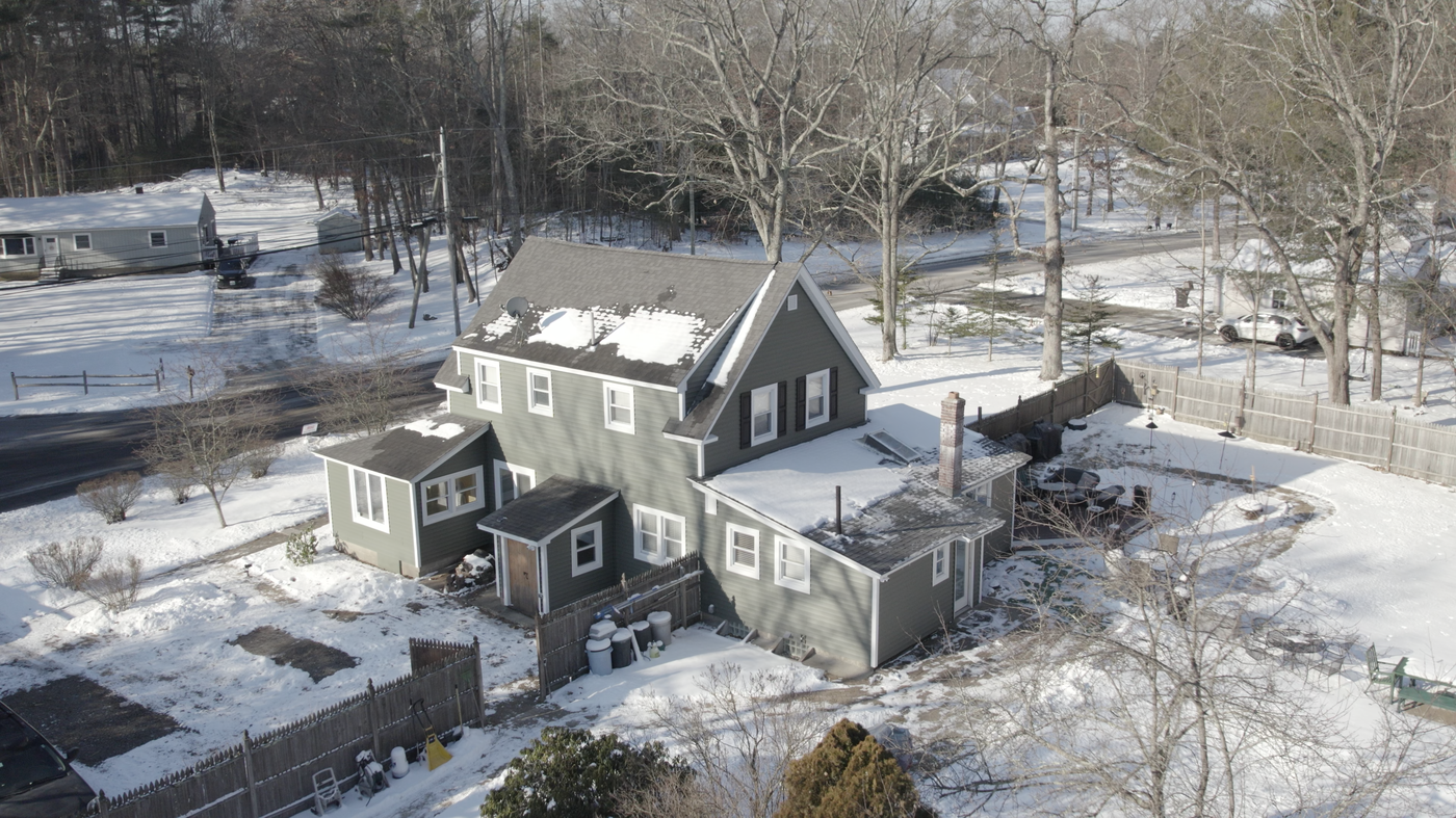 Aerial view of a winter residential property