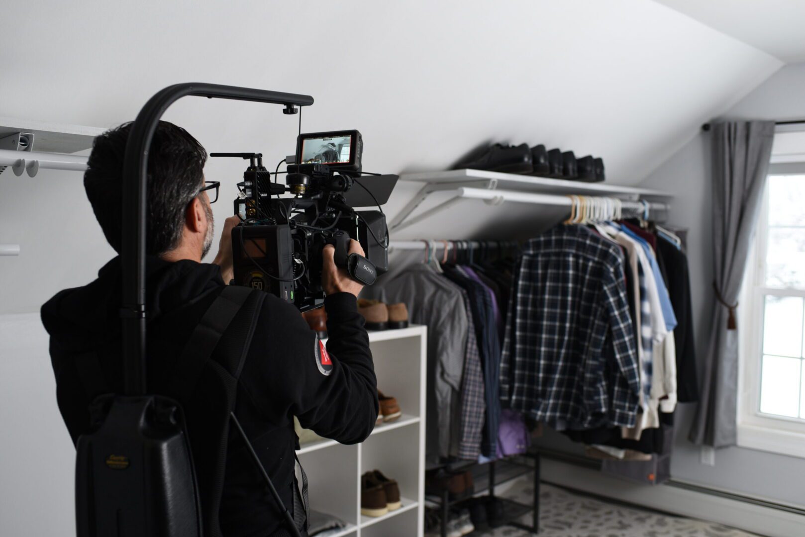 Cameraman filming inside a residential closet