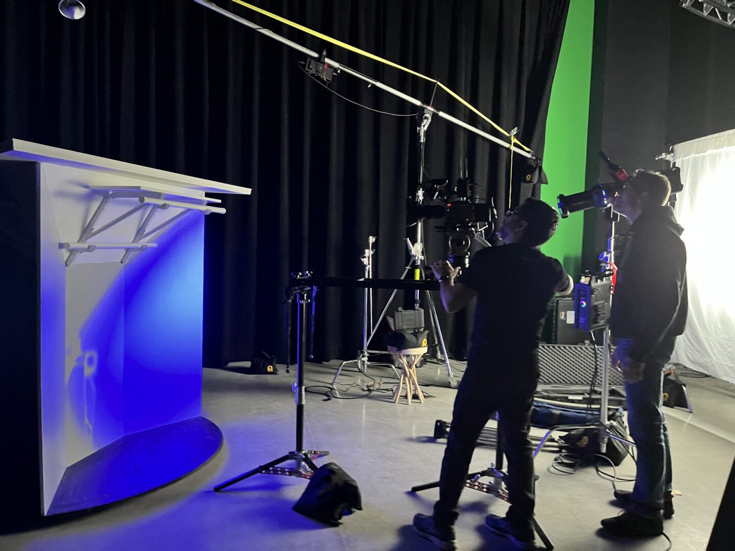Rock production crew filming a blue-lit product set