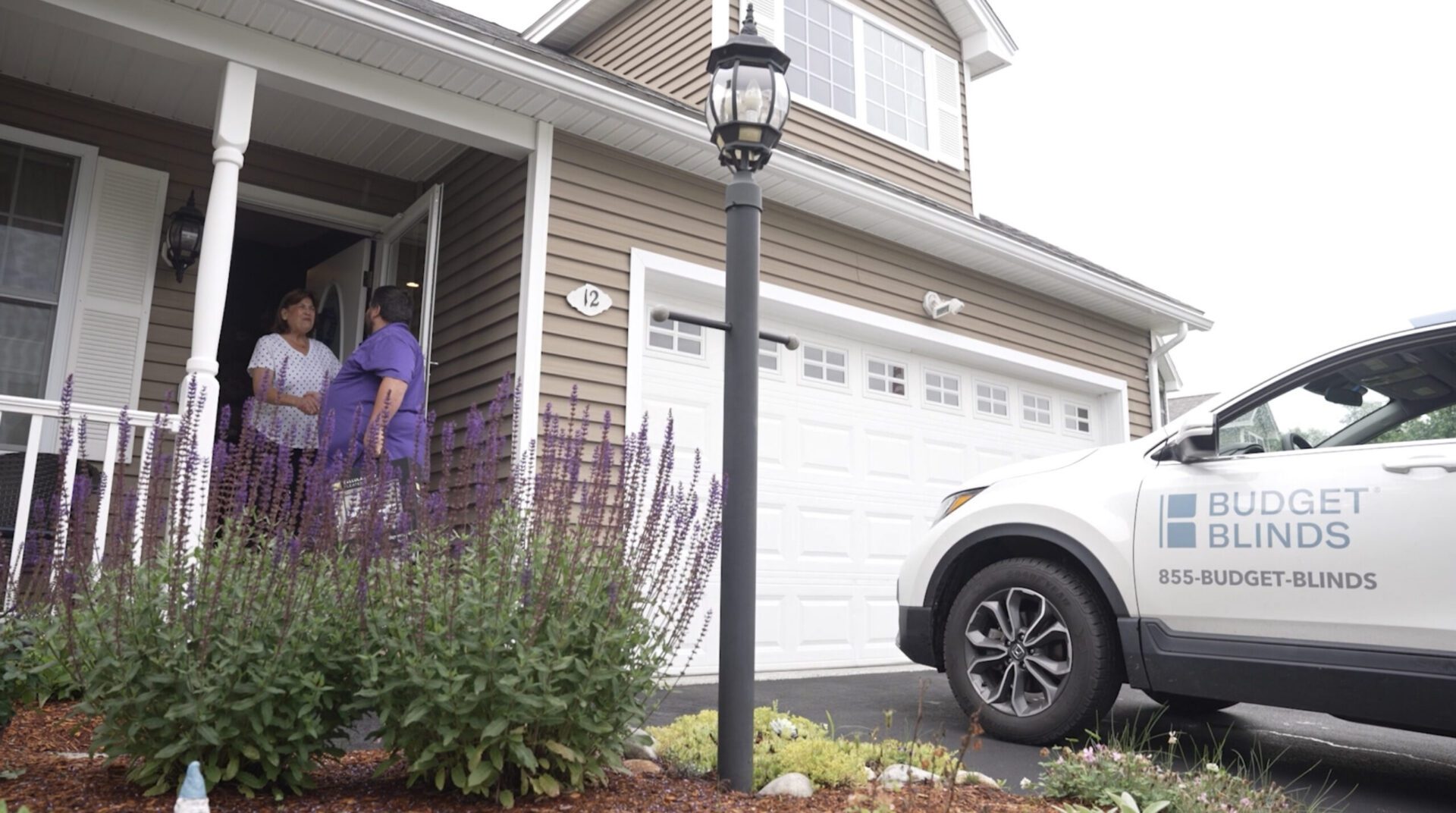 Budget Blinds vehicle parked at front porch