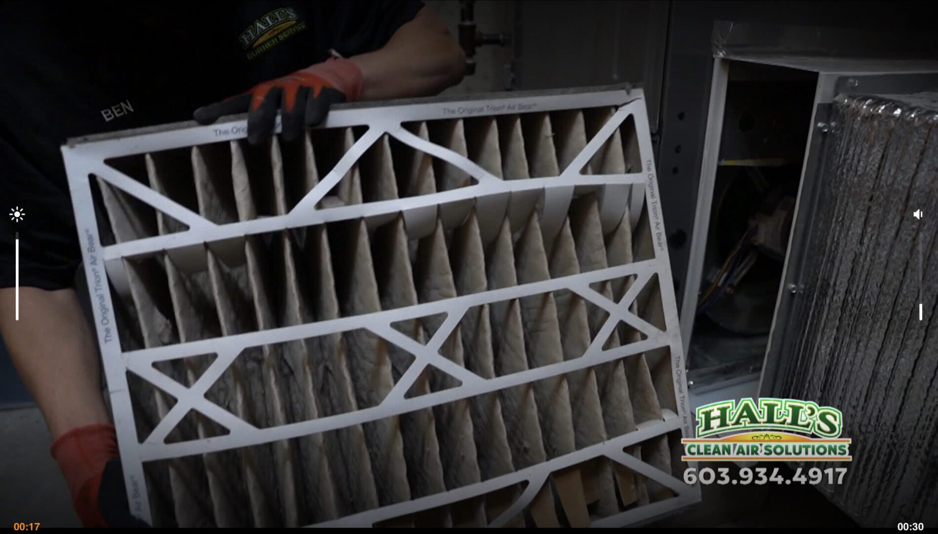 Technician removing dirty HVAC air filter