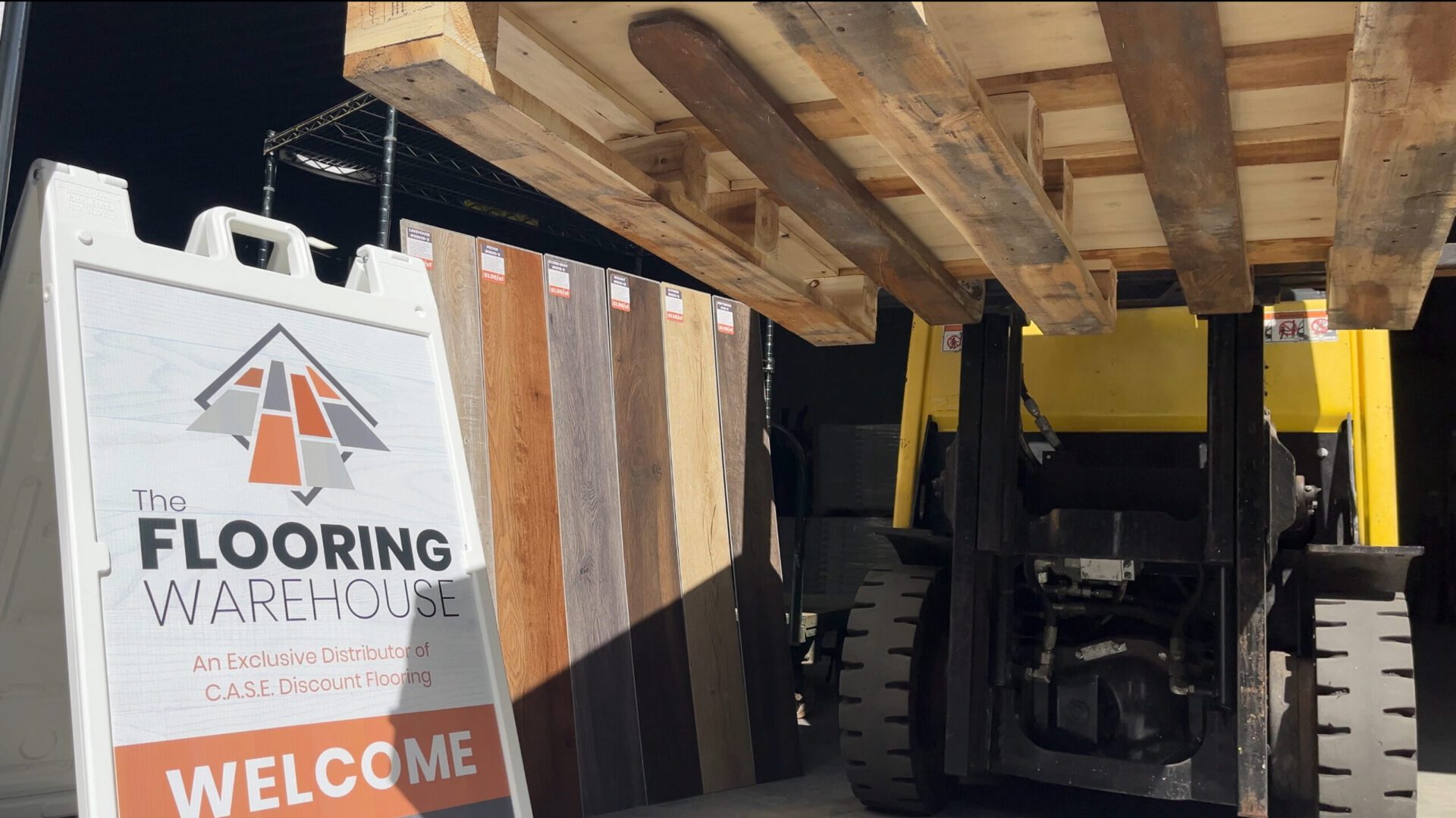 Forklift lifting pallet of reclaimed wood over samples