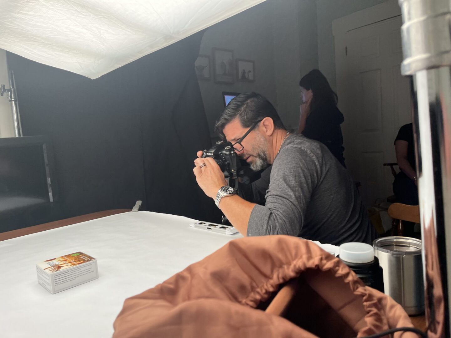 Photographer at work on a tabletop product shoot