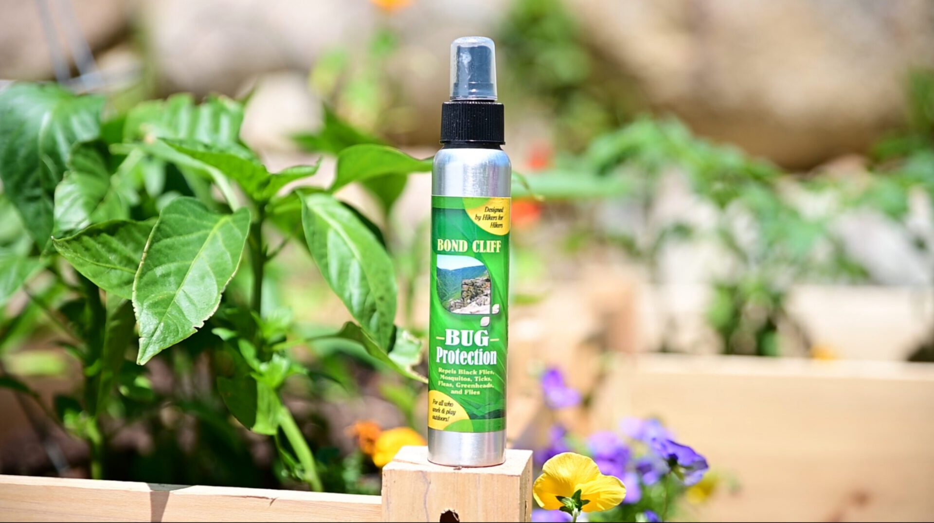 Bug protection product photographed among colorful flowers