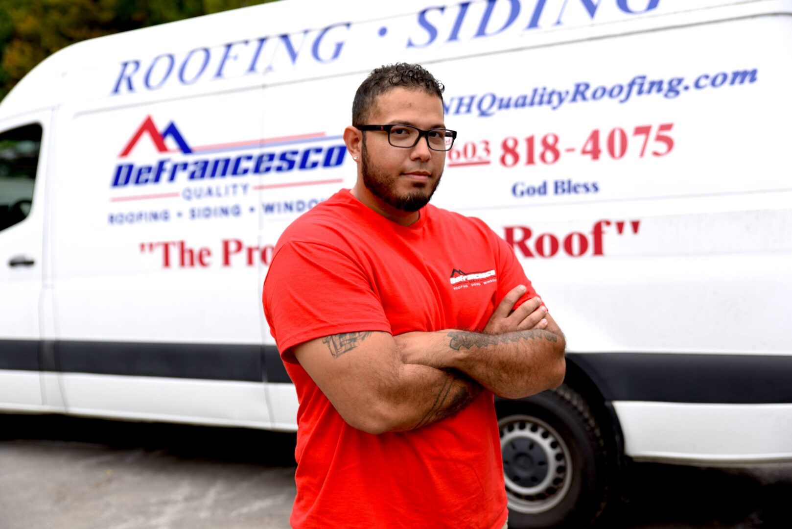 Man standing in front of roofing van.