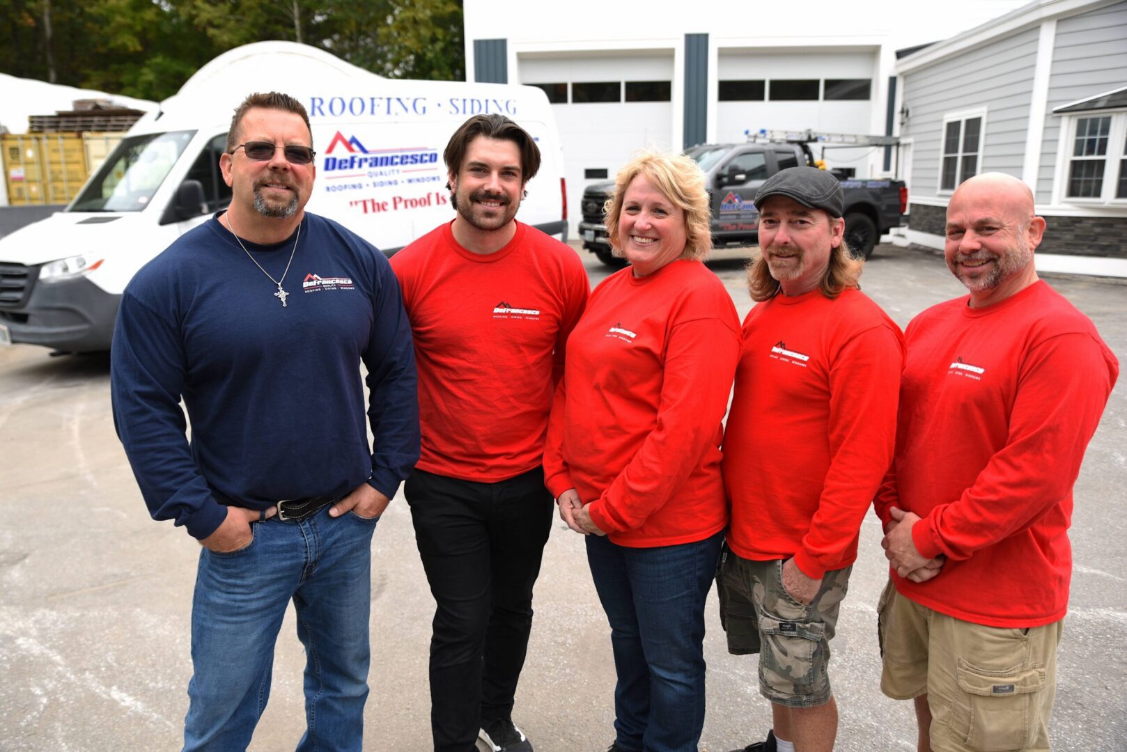 Group of people in front of vans.