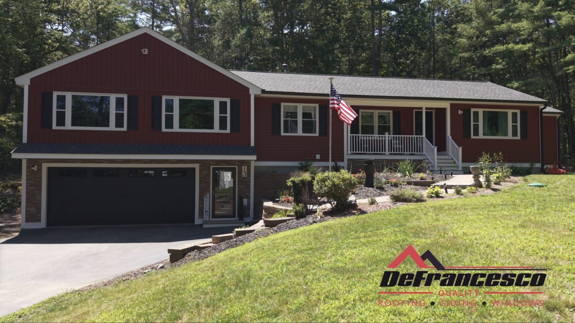 Red house with American flag and logo.
