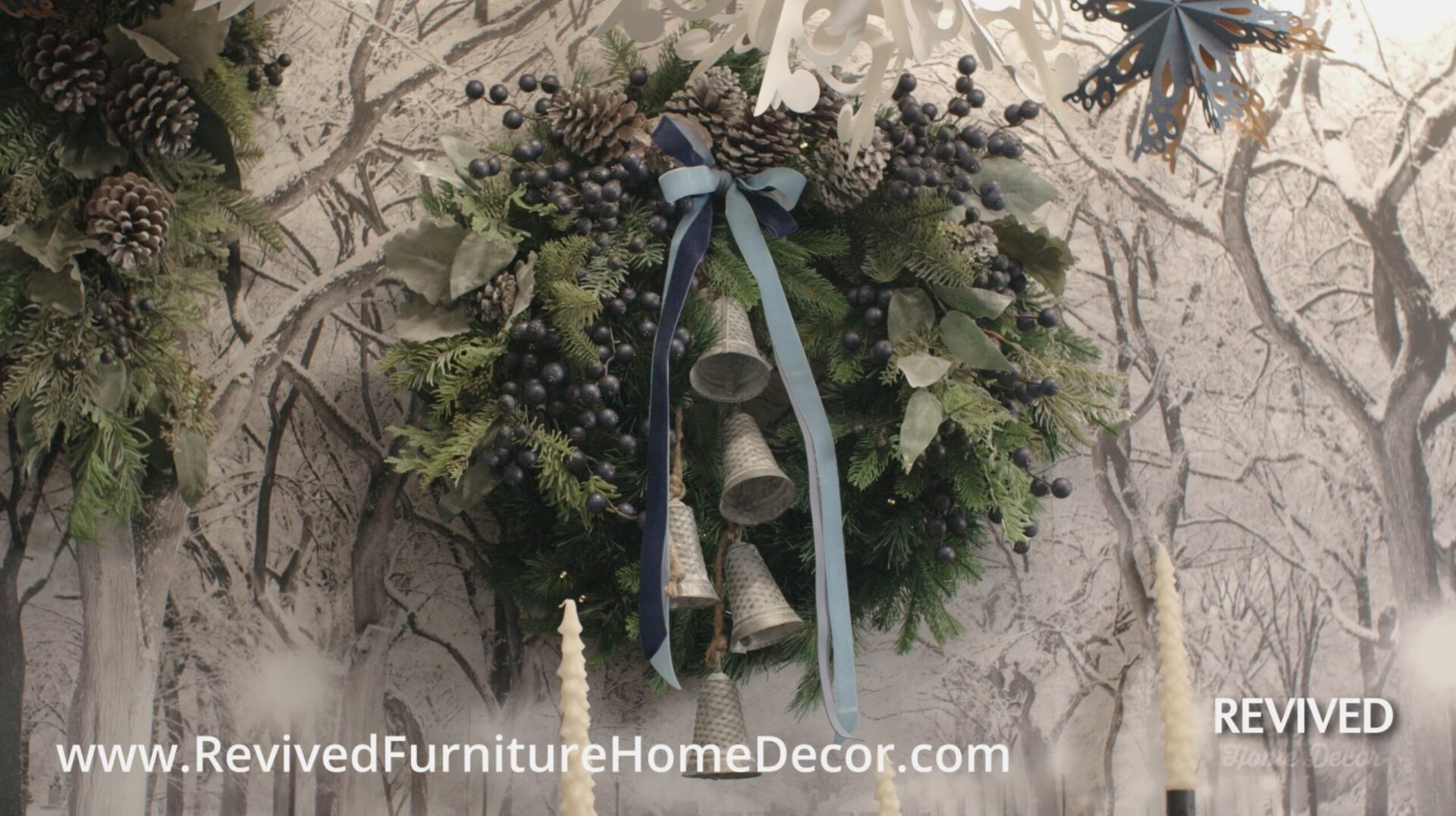 Holiday wreath with pinecones and ribbon.