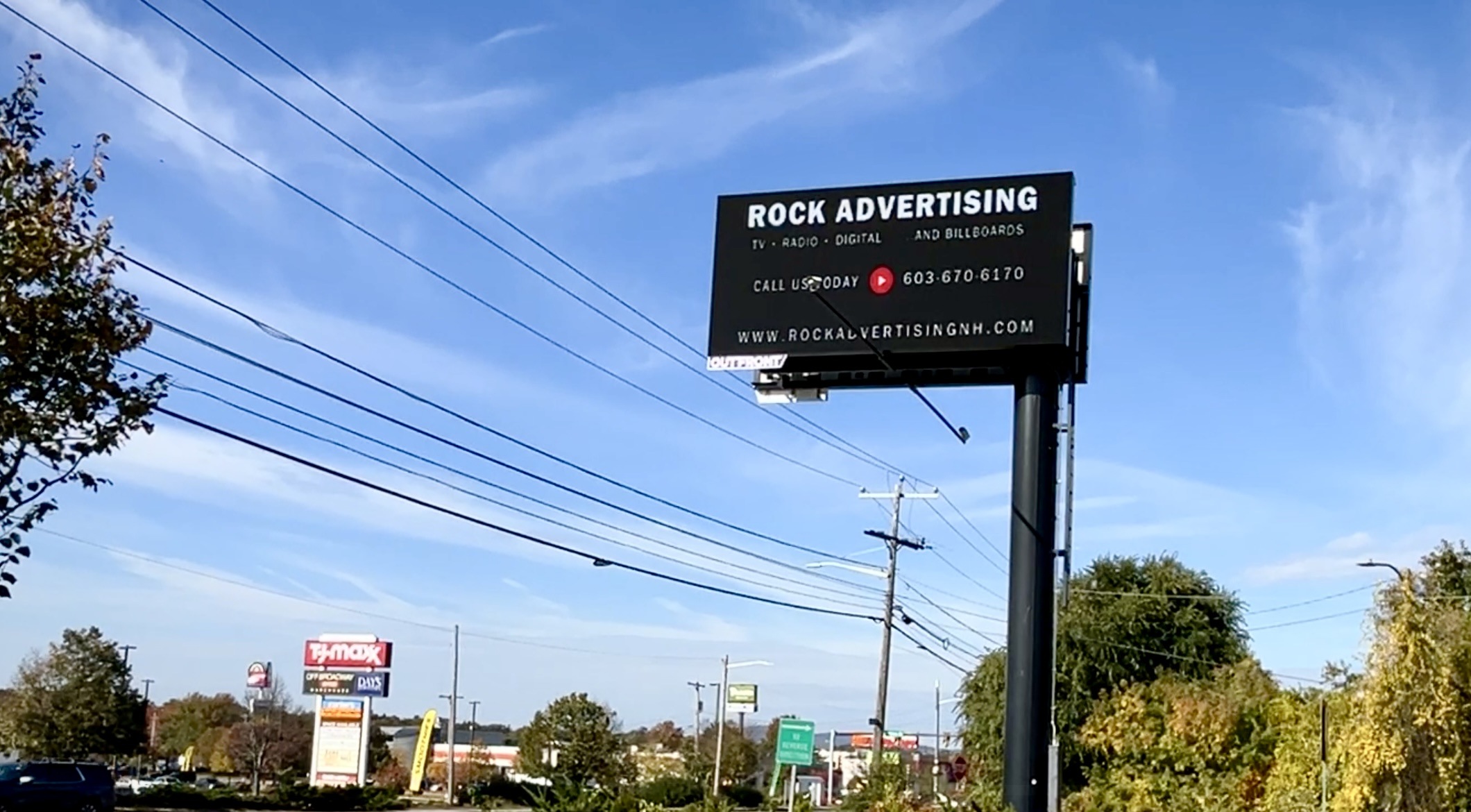 Rock Advertising digital billboard in New Hampshire against a blue sky