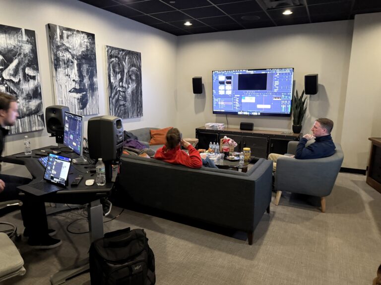 People working in a media editing room.