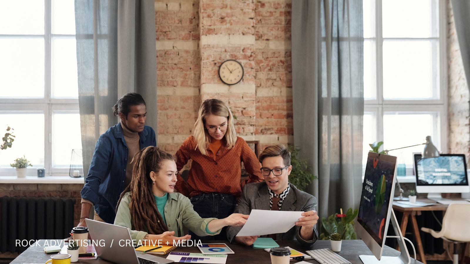 Professionals reviewing a media plan together at a desk