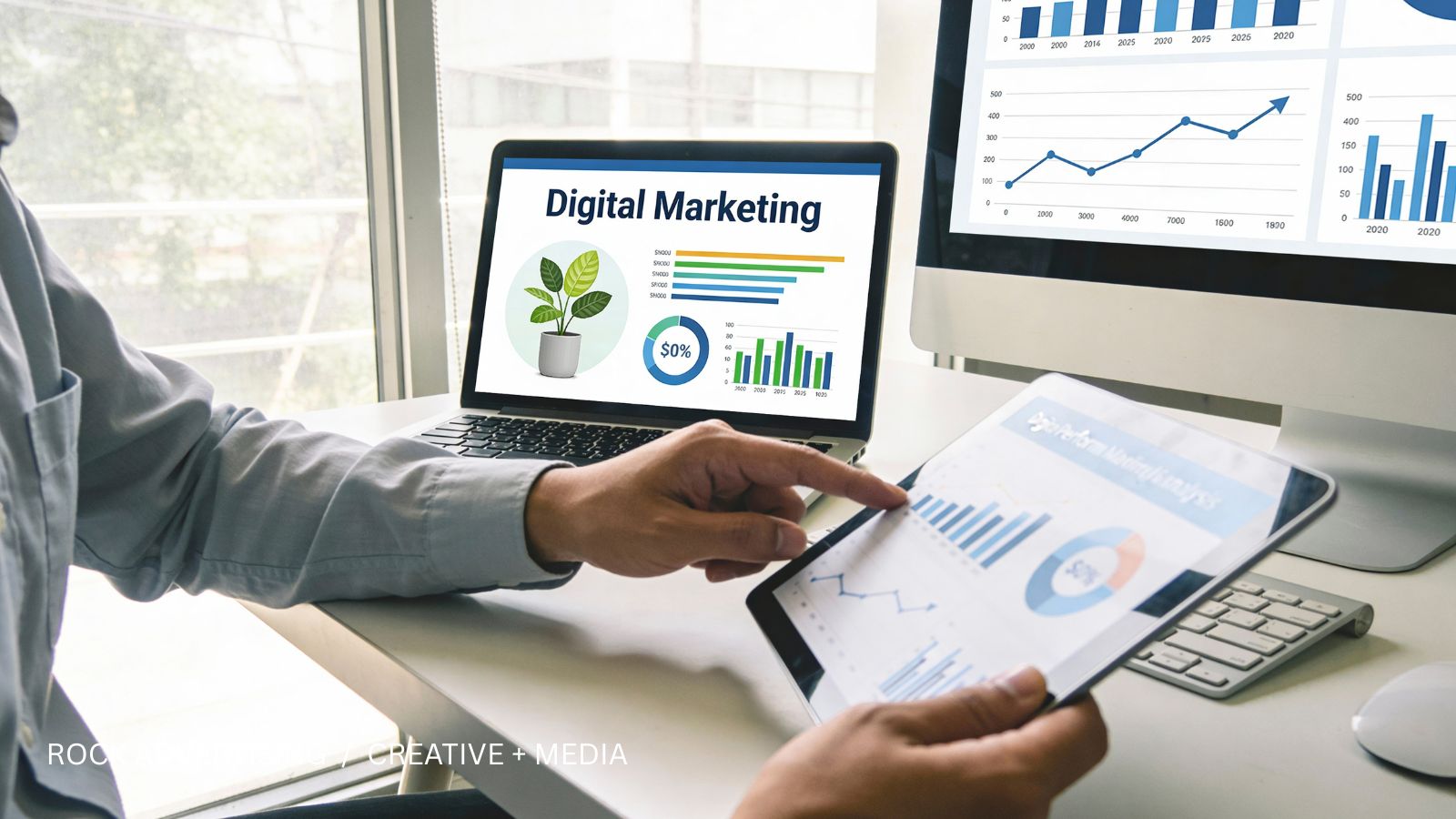 Marketing planning with audience charts on a laptop and desktop monitor